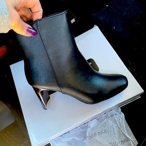 black heeled boots with gold chrome heel…